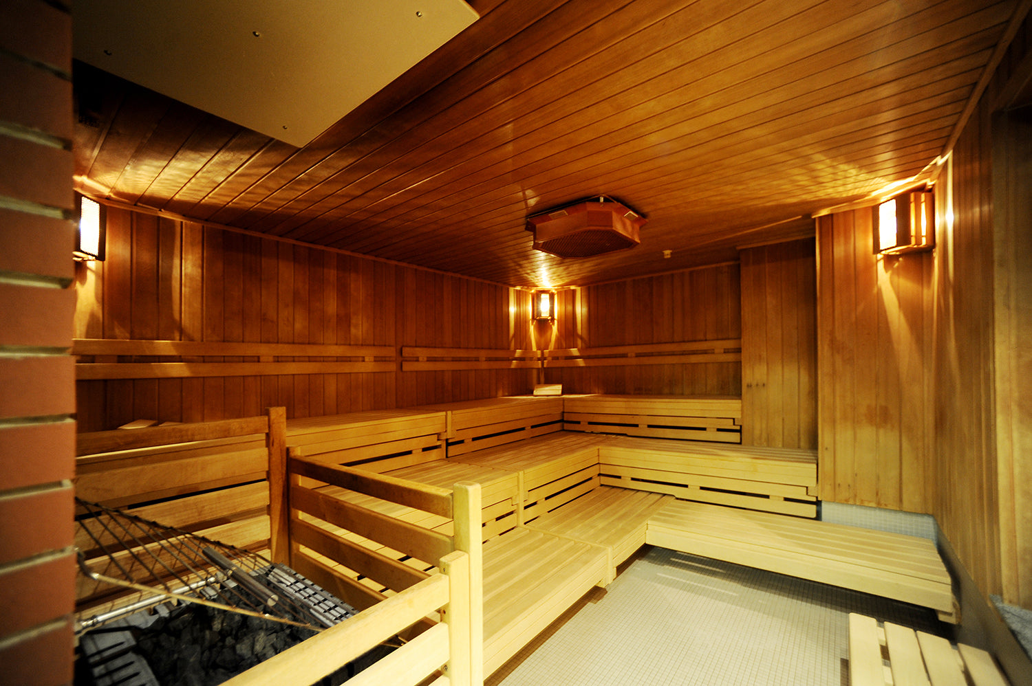 Wooden interior of a sauna with benches and walls.